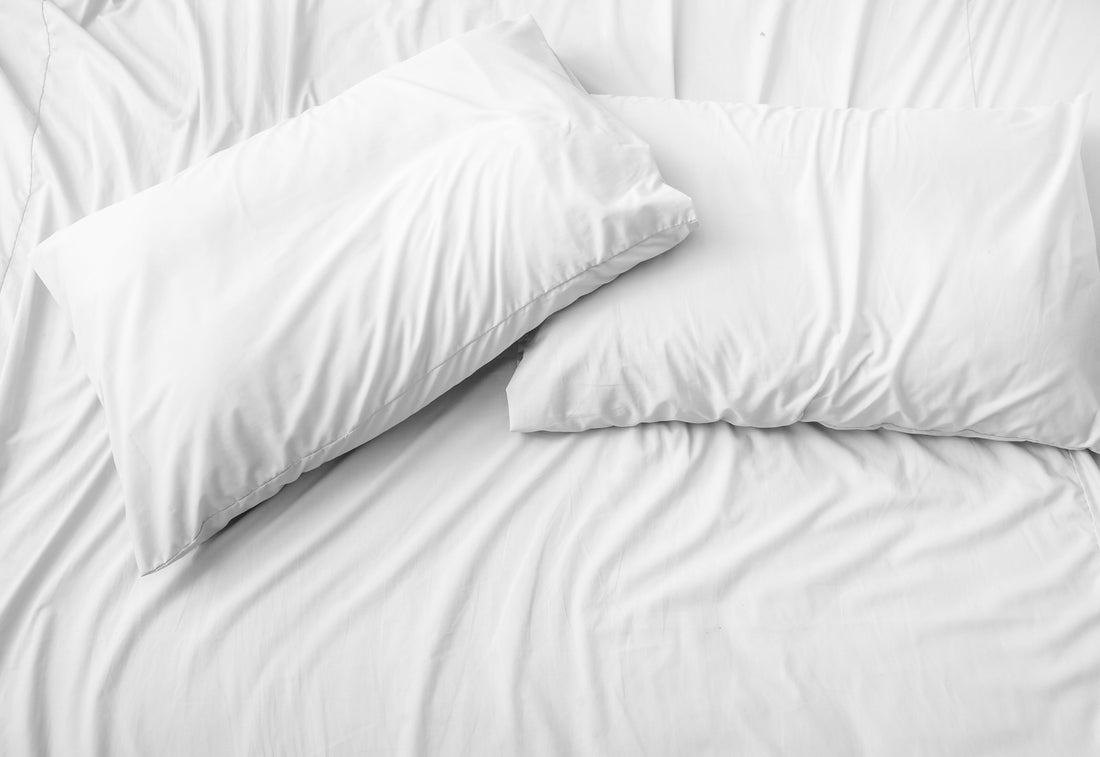 White pillows resting on a neatly made bed